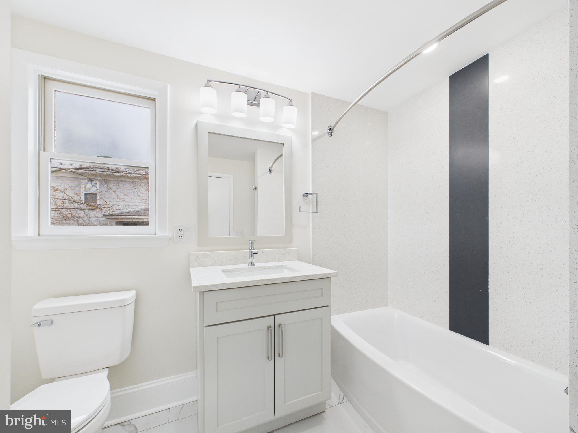 820 East Oldtown Road Cumberland, MD 21502 - Photo 16 of 40 a bathroom with a toilet a sink a tub and mirror