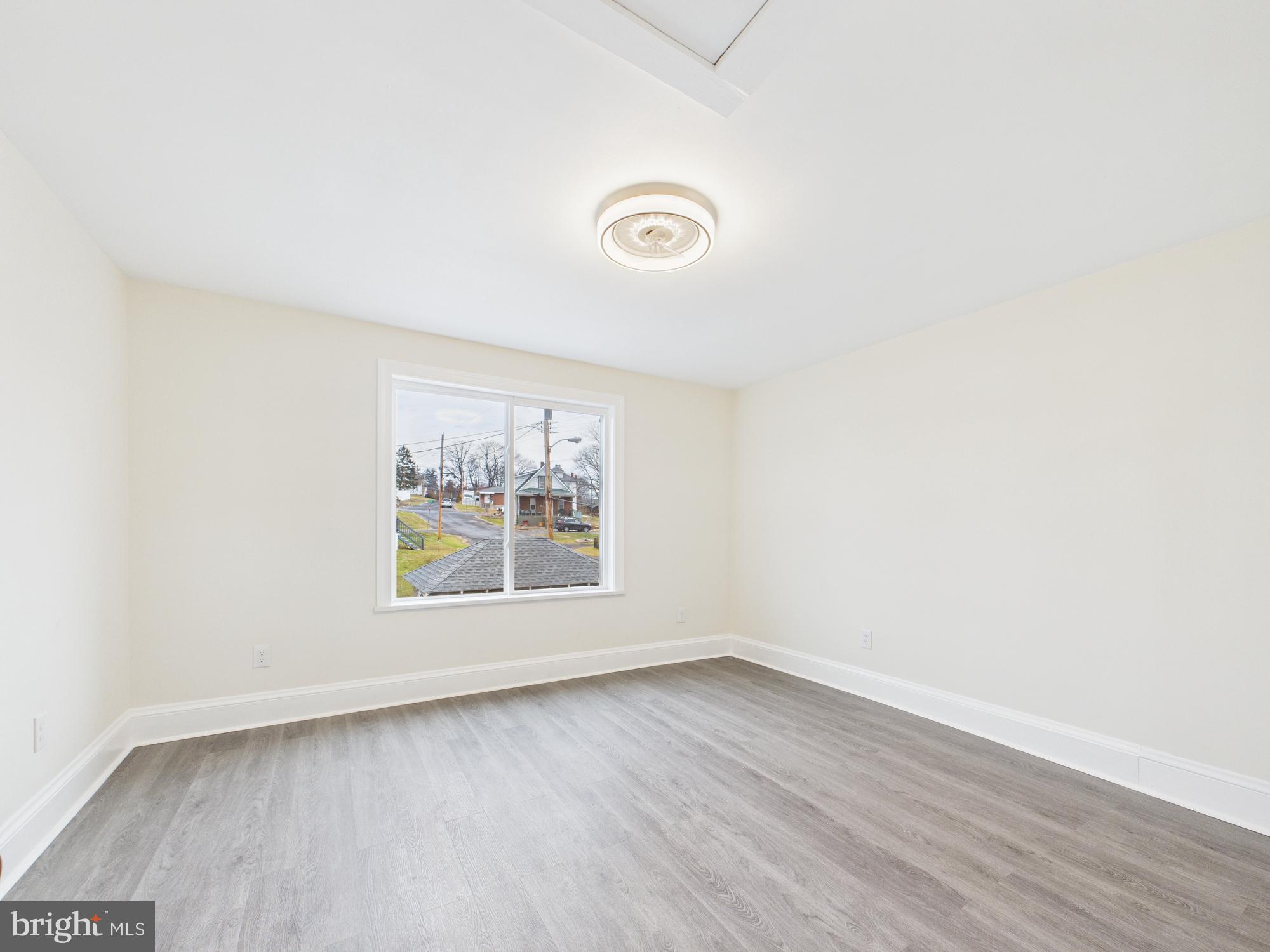 820 East Oldtown Road Cumberland, MD 21502 - Photo 22 of 40 an empty room with wooden floor and window