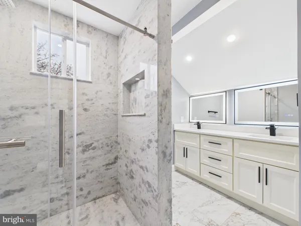 a bathroom with a granite countertop sink a toilet and shower
