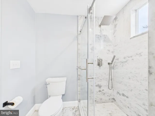 a white toilet sitting next to a bathroom sink