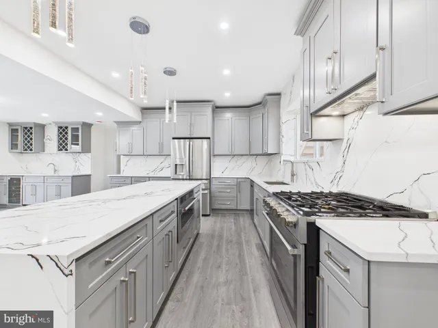 a kitchen with granite countertop a sink stove and cabinets