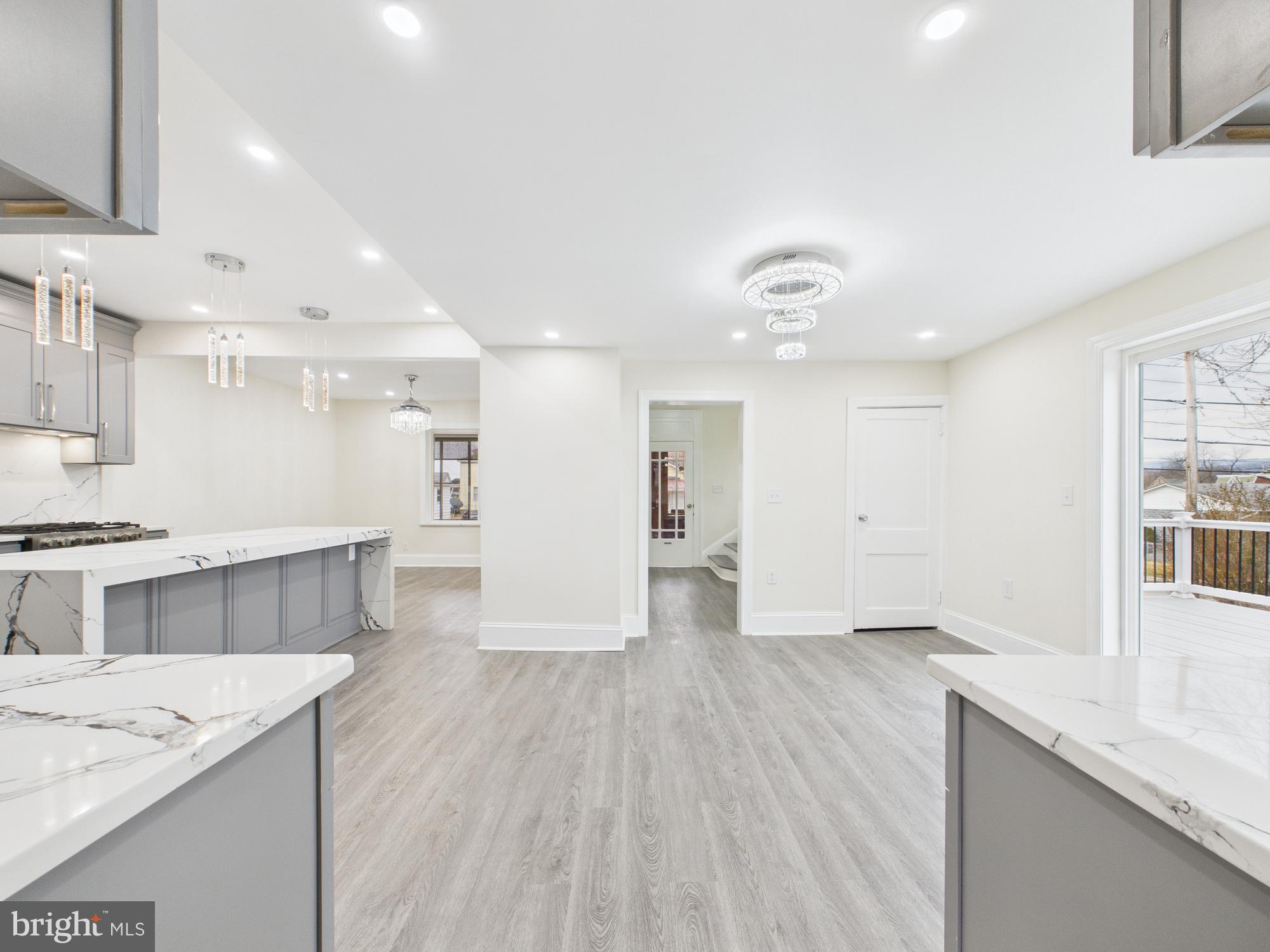 820 East Oldtown Road Cumberland, MD 21502 - Photo 4 of 40 a large kitchen with stainless steel appliances a large counter top a sink dishwasher and a stove with wooden floor