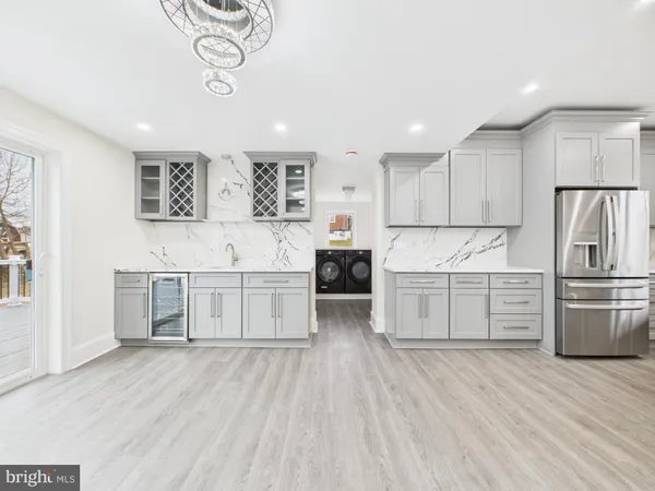 a kitchen with stainless steel appliances a refrigerator and a stove top oven