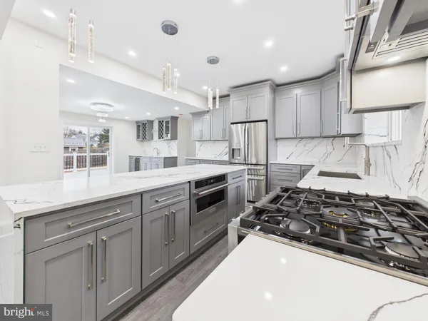 a kitchen with stainless steel appliances a sink stove and cabinets