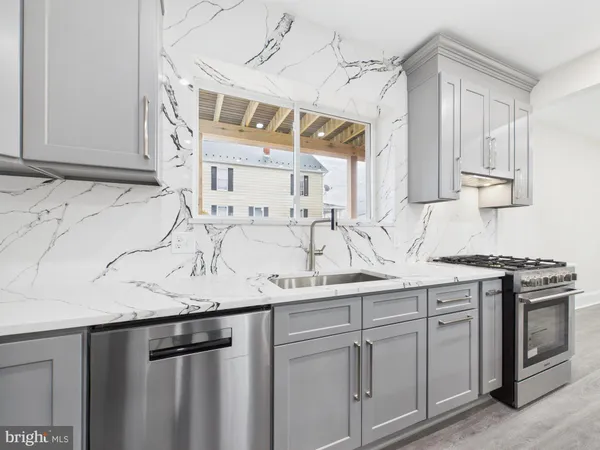 a kitchen with stainless steel appliances granite countertop a sink and cabinets