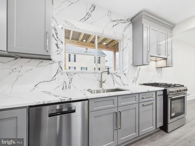 a kitchen with stainless steel appliances granite countertop a sink and cabinets