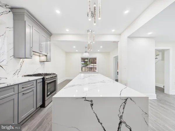 a kitchen with a stove a refrigerator and a sink