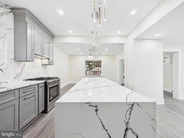 a kitchen with a stove a refrigerator and a sink