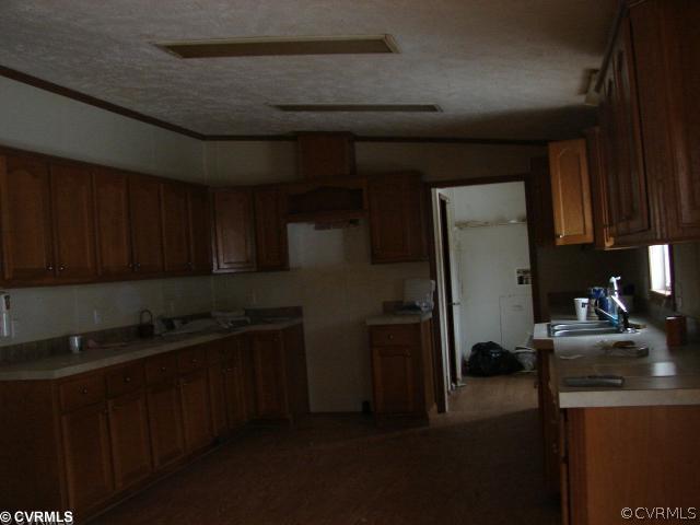 2876 Modest Creek Road Victoria, VA 23974 - Photo 2 of 4 a kitchen with a sink and cabinets