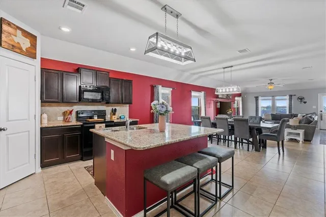 a large kitchen with a table and chairs