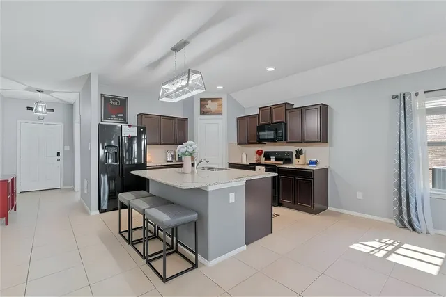 a view of kitchen with microwave and cabinets