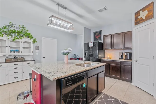 a kitchen with a stove a sink and a refrigerator