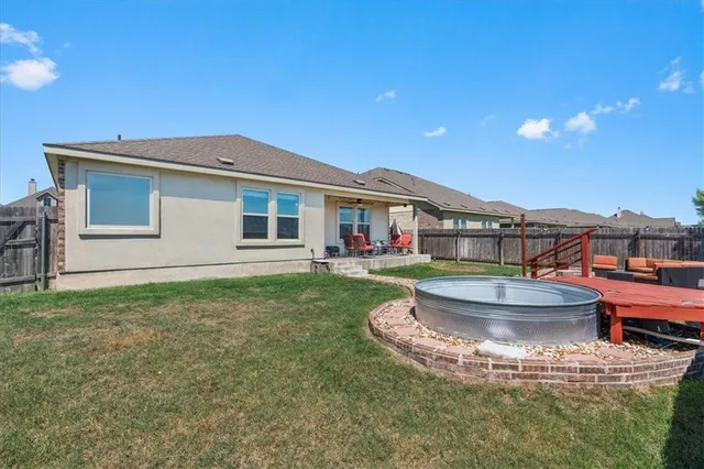 a view of a house with backyard porch and sitting area
