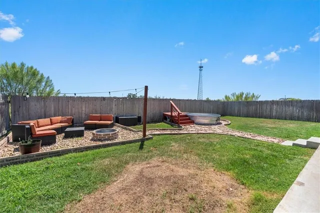 a view of a backyard with furniture