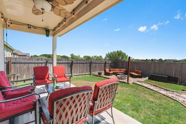 a view of a chairs and table in the patio