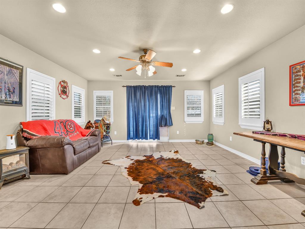 325 Huggins Drive Springtown, TX 76082 - Photo 10 of 28 a bedroom with a bed and a chandelier