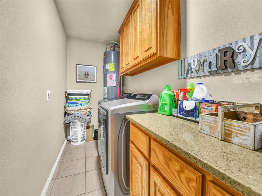 325 Huggins Drive Springtown, TX 76082 - Photo 12 of 28 a kitchen with stainless steel appliances granite countertop a sink and cabinets