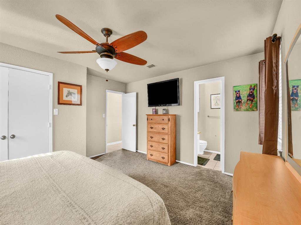 325 Huggins Drive Springtown, TX 76082 - Photo 13 of 28 a bedroom with a bed and a flat screen tv