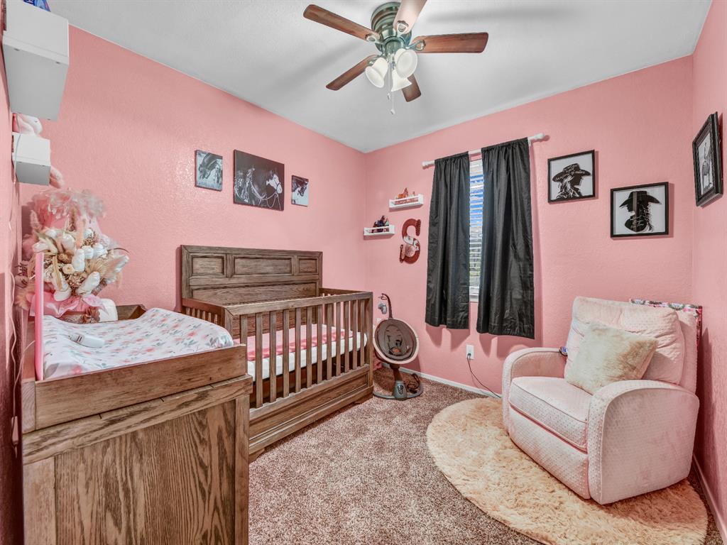325 Huggins Drive Springtown, TX 76082 - Photo 16 of 28 a bedroom with furniture and a window