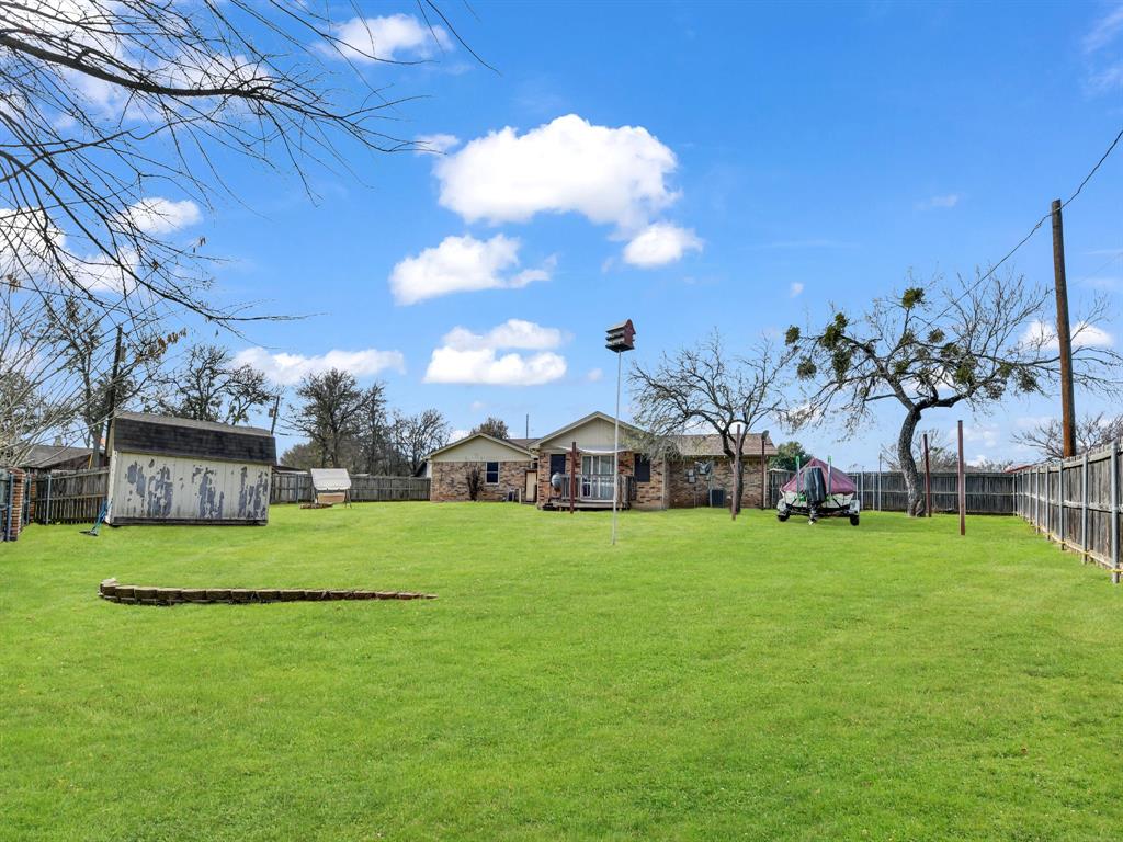 325 Huggins Drive Springtown, TX 76082 - Photo 19 of 28 a view of a big yard with a house