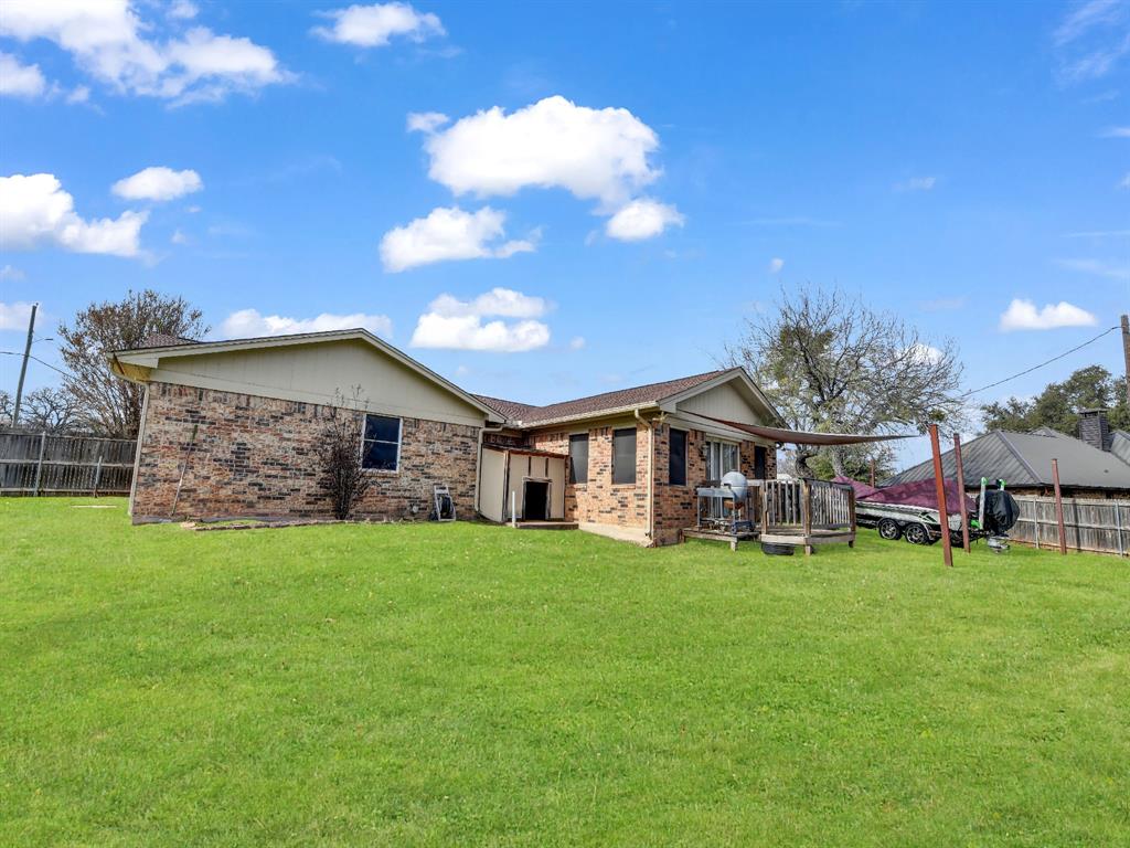 325 Huggins Drive Springtown, TX 76082 - Photo 21 of 28 a view of a house with a yard and sitting area