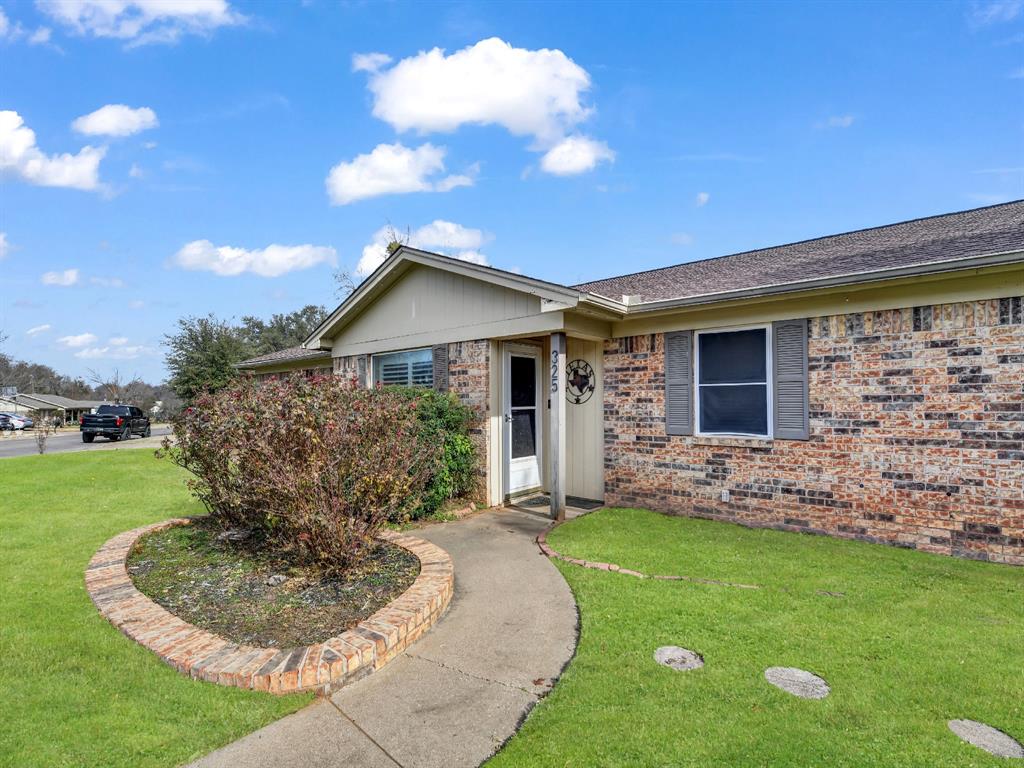 325 Huggins Drive Springtown, TX 76082 - Photo 27 of 28 a front view of a house with a yard