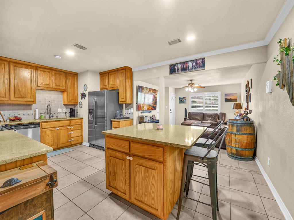 325 Huggins Drive Springtown, TX 76082 - Photo 4 of 28 a kitchen with stainless steel appliances granite countertop a sink and cabinets