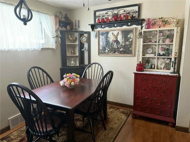 a view of a dining room with furniture and chandelier