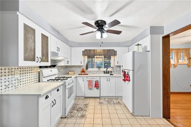 a kitchen with a stove a refrigerator and a sink
