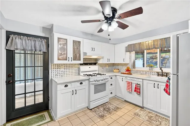 a kitchen with a stove a sink and a microwave