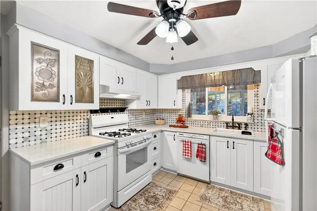 a view of a room with wooden floor and a ceiling fan