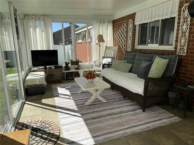 a building outdoor space with patio furniture and potted plants