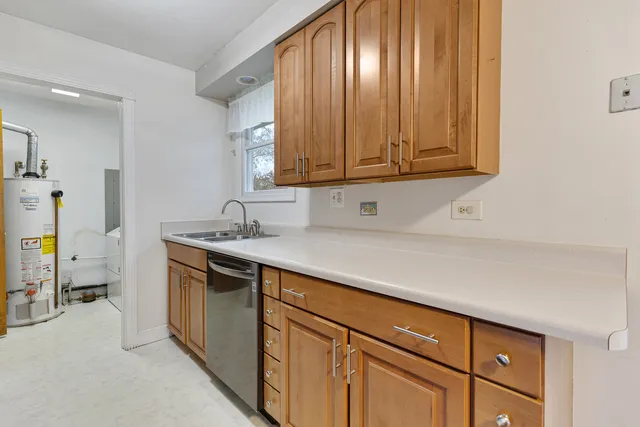 a kitchen with a sink cabinets and a window