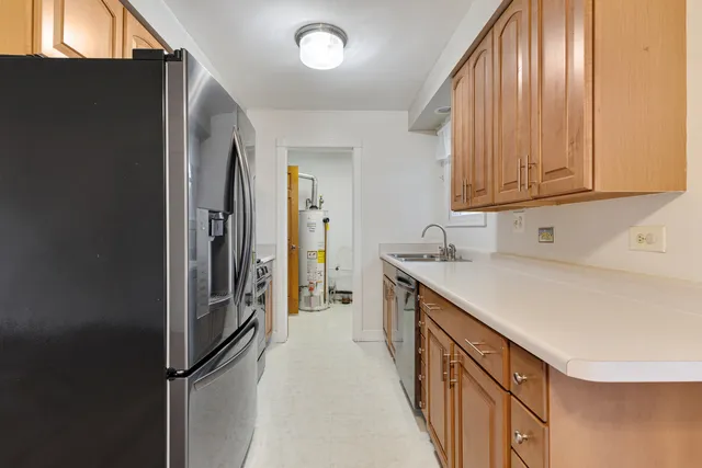 a kitchen with stainless steel appliances granite countertop a refrigerator and a sink
