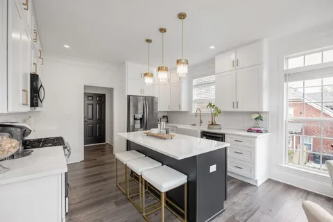 a kitchen with a counter space a sink appliances and cabinets