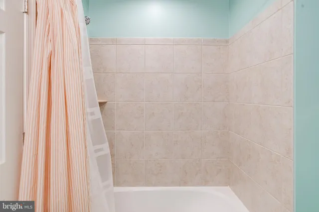 a bathroom with a shower curtain and curtain