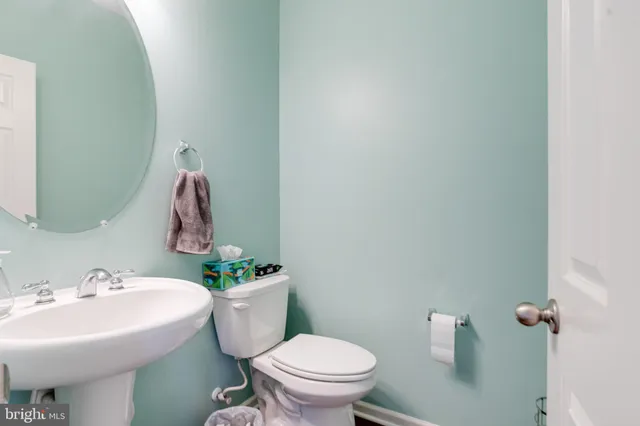 a bathroom with a sink mirror and toilet