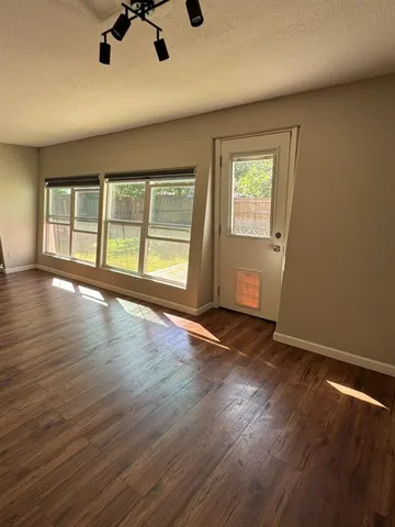 a kitchen with granite countertop a sink a stove and cabinets