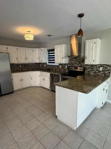 a view of an empty room with window and fireplace