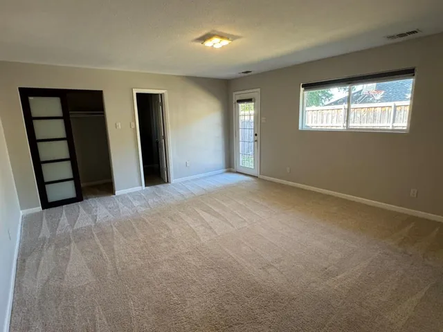 a bathroom with a toilet sink vanity and mirror