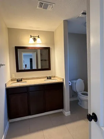 a bath tub sitting next to a white sink and vanity