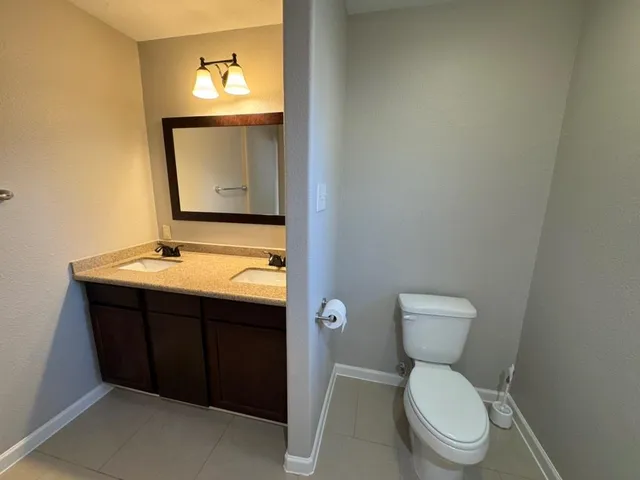 a view of an empty room with closet and a window