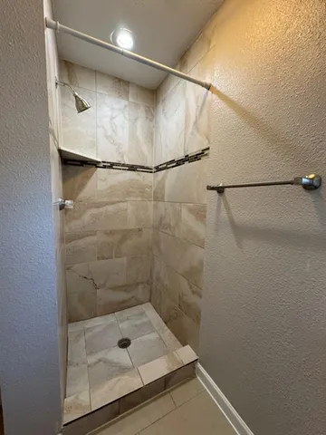 an empty room with windows and wooden floor