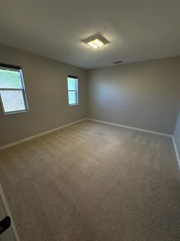 a view of an empty room with windows