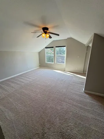 a view of backyard with wooden fence