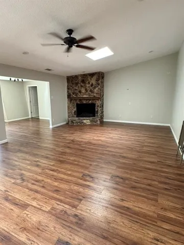 a view of a room with wooden floor