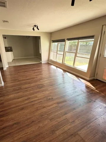 a large kitchen with cabinets appliances a sink and a counter top space