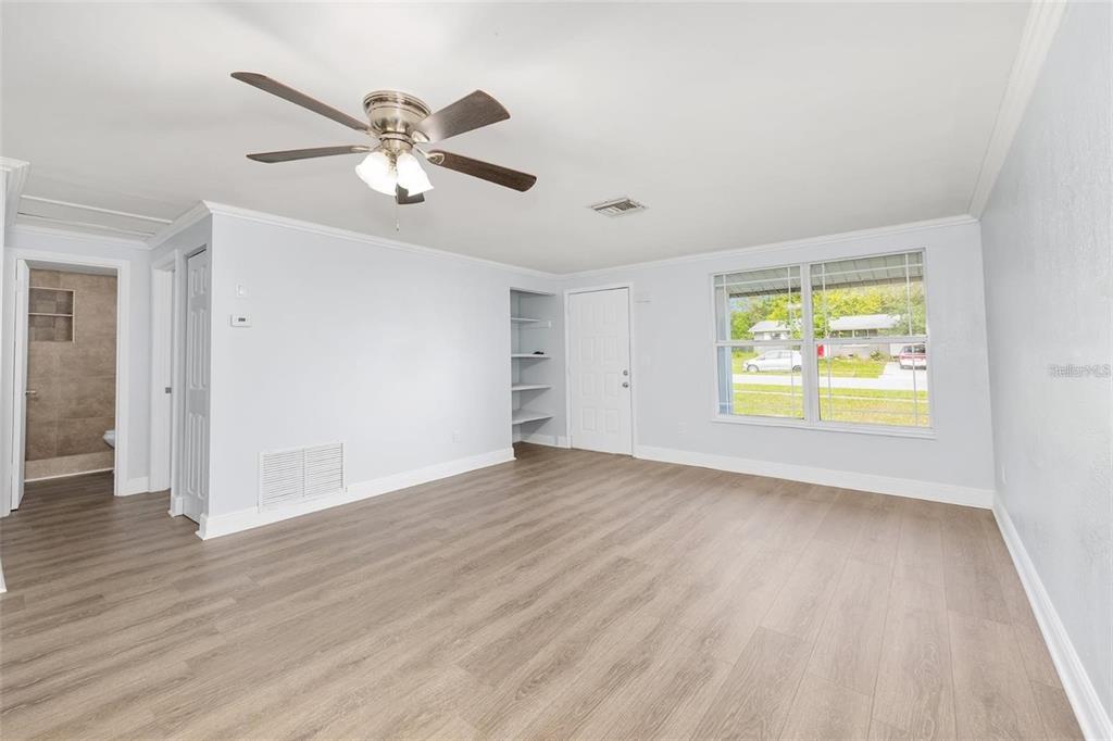 14761 Southwest 35th Terrace Road Ocala, FL 34473 - Photo 3 of 13 a view of an empty room with wooden floor and a window