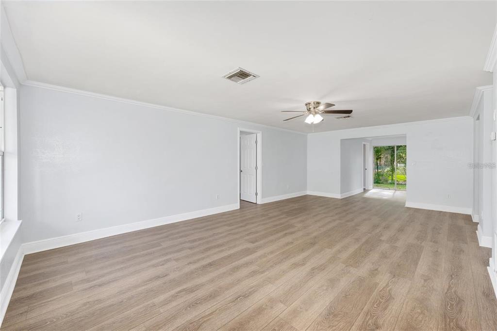 14761 Southwest 35th Terrace Road Ocala, FL 34473 - Photo 4 of 13 a view of empty room with wooden floor and ceiling fan