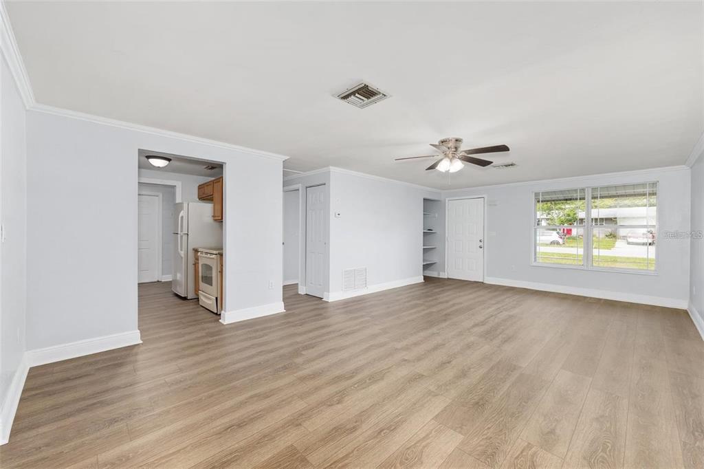 14761 Southwest 35th Terrace Road Ocala, FL 34473 - Photo 5 of 13 a view of an empty room with a window and wooden floor
